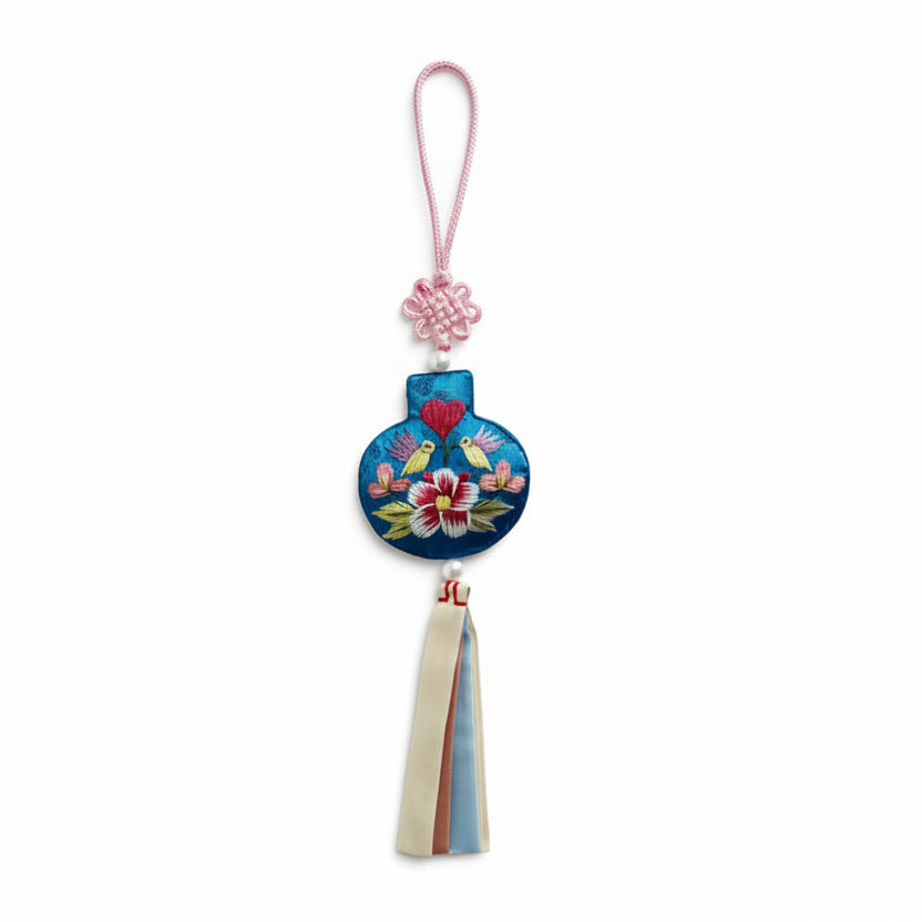 Decorative keychain with floral design on a white background