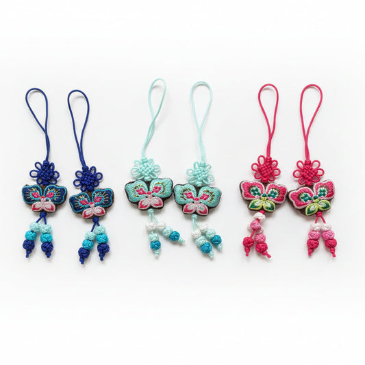 Colorful decorative items with floral designs on a textured fabric background